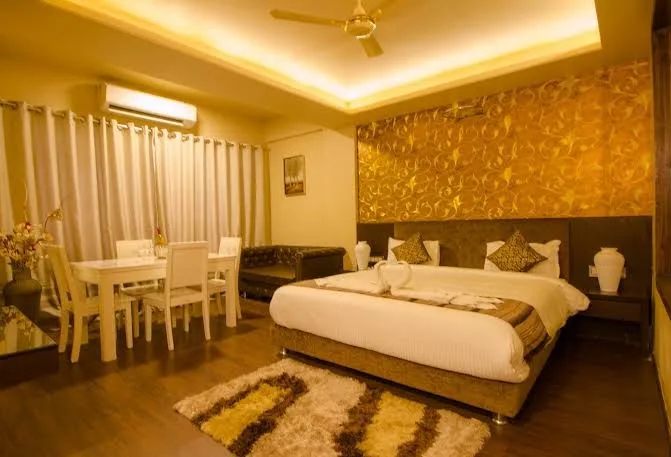 A warmly lit luxury suite at Hotel Mittal Paradise